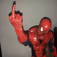 a statue of spider-man giving the middle finger