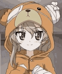 a girl is wearing a teddy bear costume and holding a bandage on her head .