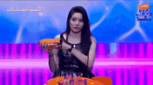 a girl is holding a nickelodeon prize in her hands