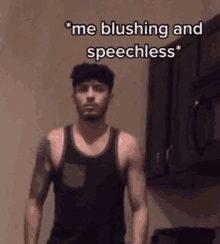 a man in a black tank top says " me blushing and speechless " in a kitchen