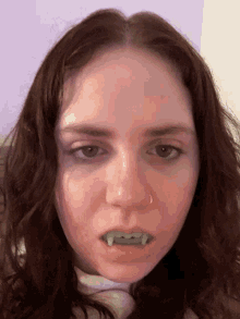 a close up of a woman 's face with fake teeth on her mouth