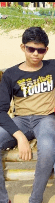 a man wearing sunglasses and a shirt that says touch