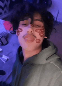 a young man with kisses on his face