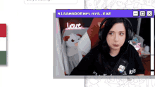 missmaddenplays.exe is displayed on the screen of a woman