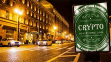 a green sign on the side of a street says crypto advertising coin