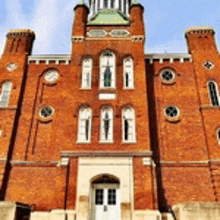 a large brick building with a clock on top