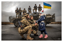 a group of soldiers are posing for a picture with a little girl and a flag in the background