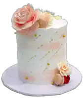 a white cake with pink roses and macarons on top