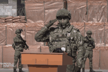 a soldier salutes in front of a podium with anadolu kartali written on it