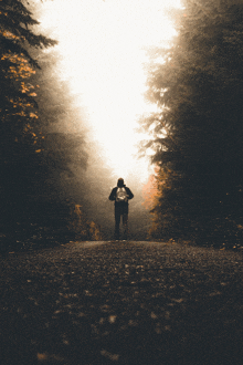 a man with a backpack walking down a road