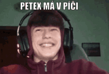 a young man wearing headphones is smiling and says petex ma v pici in white letters