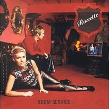 a woman is laying on the floor next to a man on a couch in a room service album cover