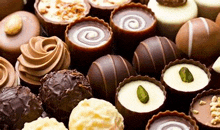 a variety of chocolate candies are sitting on a table .