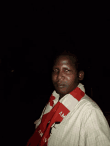 a man wearing a red and white scarf that says amv