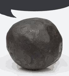 a black rock with a speech bubble in the background