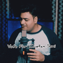 a man singing into a microphone with the words vote for chetan soni written on the bottom