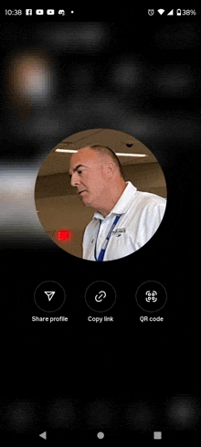 a man in a white shirt is in a circle on a cell phone screen