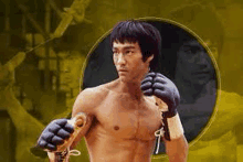 bruce lee is a martial artist without a shirt and holding a sword .