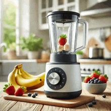 a blender with strawberries and bananas in it sits on a wooden table