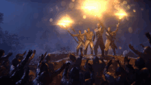 a group of men are holding torches in the dark