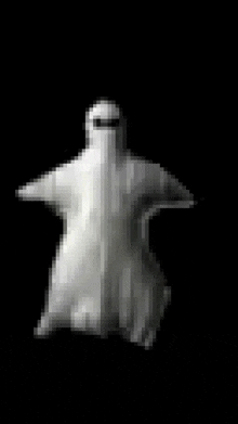 a white ghost is standing on a black surface .