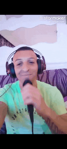 a man wearing headphones singing into a microphone