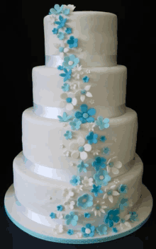 a white cake with blue flowers on it