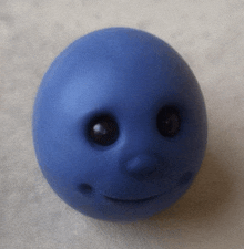 a blue ball with a smiley face on it 's face