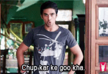 a man wearing a t-shirt that says ' chup kar ke goo kha '