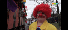 a man dressed as a clown with a yellow jacket on