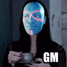 a woman with a blue face is holding a cup and saucer with gm written on the bottom