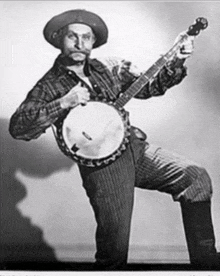 a man with a beard is playing a banjo