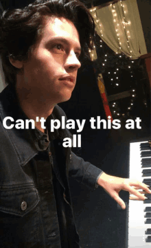 a young man playing a piano with the words " can 't play this at all " below him