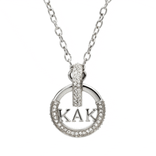 a silver necklace with a pendant that says kak on it