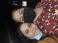 two women wearing face masks are posing for a picture together