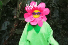 a person wearing a flower costume and sunglasses is standing in the woods .