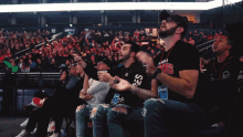 a group of people sitting in a stadium with one man wearing a shirt that says ' chicago bulls '