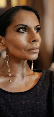 a close up of a woman 's face with a nose ring