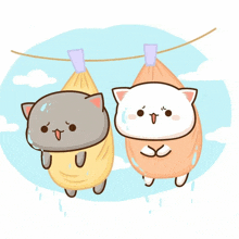 two cartoon cats are hanging on a clothesline