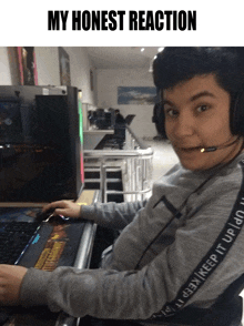 a young man wearing headphones is sitting in front of a computer with the words " my honest reaction " above him