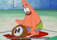 patrick star from spongebob squarepants is kneeling down on a mat holding a ball with a n on it .