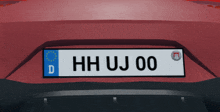 a red car with a license plate that reads hh uj 00