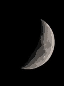 a close up of a crescent moon against a black sky