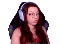 a woman wearing glasses and headphones is sitting in a chair with twitch.tv/flamma written on the bottom