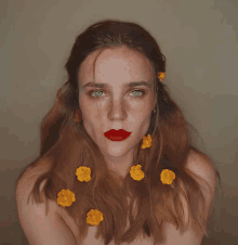 a woman with yellow flowers in her hair and red lips