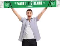 a man holds up a green scarf with saint etienne handball written on it