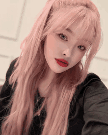 a girl with long pink hair and red lips is taking a selfie