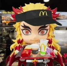 a doll is wearing a mcdonald 's hat and holding a tray of food in a mcdonald 's .