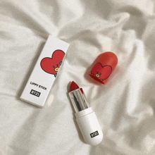 a lippy stick from bt21 sits on a bed