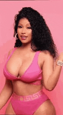 nicki minaj is wearing a pink bikini top and bottoms .